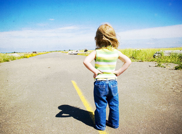 Child facing the open road